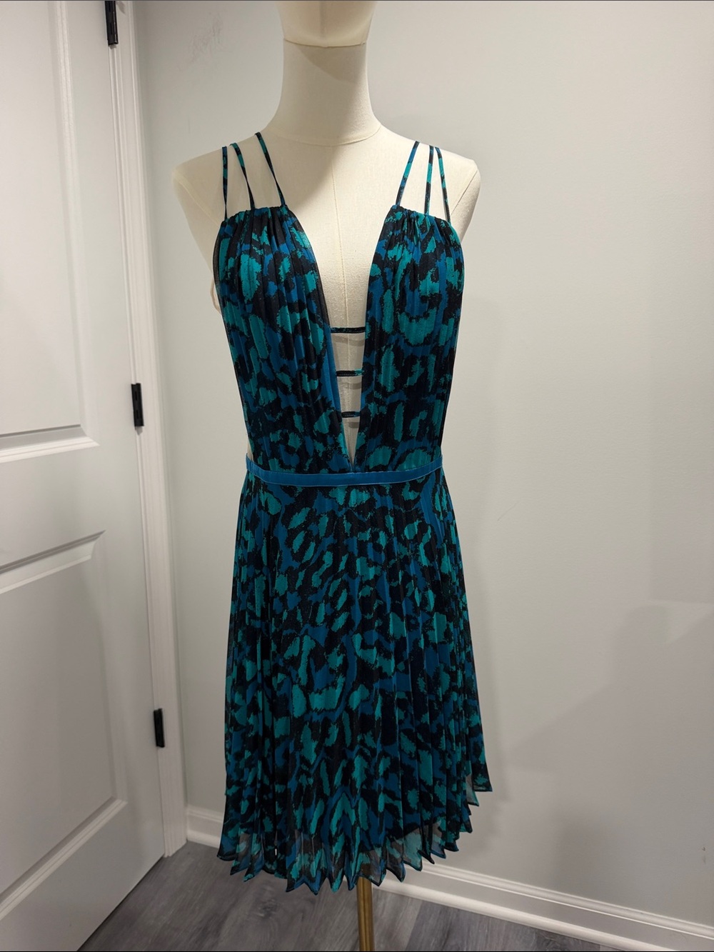 BEBE Blue and Teal Printed Pleated Chiffon Dress with sheer mesh on sides.